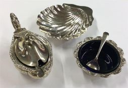 A scallop-shaped silver butter dish together with