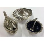 A scallop-shaped silver butter dish together with