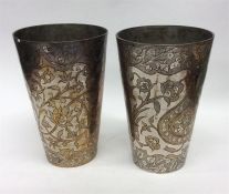 A pair of heavy Indian goblets decorated with flow
