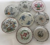 A quantity of various Faience plates decorated wit