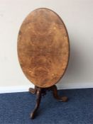 A small walnut inlaid occasional table on three sc