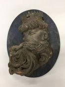 An oval panel depicting a Greek God. Approx. 40 cm