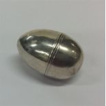 An egg-shaped silver nutmeg grater of plain design