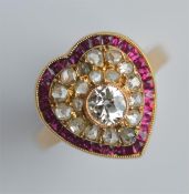 An attractive ruby and diamond heart-shaped ring w