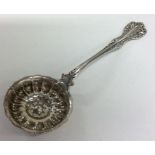 A Continental silver sifter spoon with pierced bow