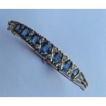 A heavy 9 carat diamond-mounted hinged bangle with