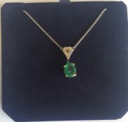 A large oval emerald-mounted as a pendant on fine
