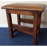 An oak carved stool with leather top. Est. £20 - £