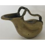 A brass ewer with rope twist handle and masked fig