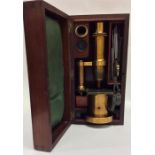 A good quality mahogany cased microscope complete