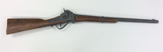 An old mahogany-mounted rifle. Est. £30 - £50.