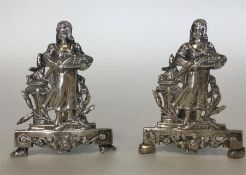 A pair of unusual silver menu holders in the form