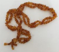 A double string of amber beads with matching tasse
