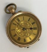 A small 9 carat fob watch with gilt dial. Approx.