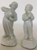A pair of white-glazed porcelain figures modelled