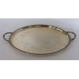 A heavy plain silver tea tray with Celtic-work dec