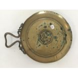 A heavy brass circular dish with snake decoration