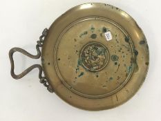 A heavy brass circular dish with snake decoration