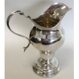 A Georgian-style silver helmet shaped cream jug wi