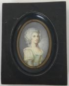 An oval miniature of a lady in green dress with wav