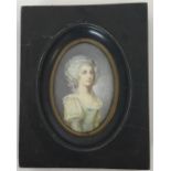 An oval miniature of a lady in green dress with wav