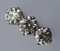 A diamond three stone ring attractively mounted in
