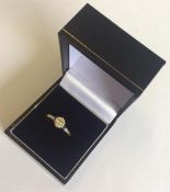 A gold and diamond single stone ring in 18 carat p