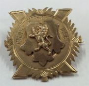 A 9 carat gold badge depicting a lion upon a shiel