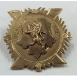 A 9 carat gold badge depicting a lion upon a shiel