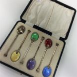 A boxed set of six silver and enamel coffee spoons