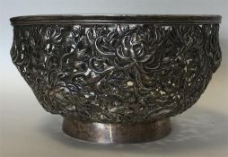 A good Chinese silver bowl decorated with flowers