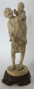 A good Antique carved ivory figure of a man with b