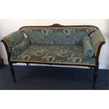 A good Edwardian scroll end sofa on turned support