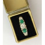 A large emerald and diamond five stone ring in 18