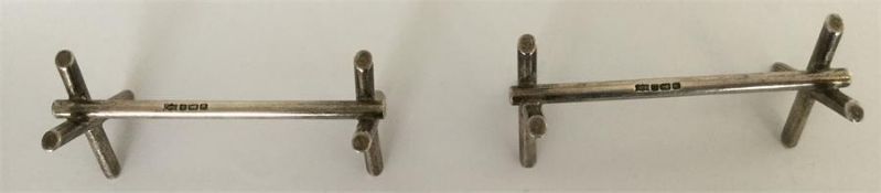 A heavy pair of cast silver knife rests. Sheffield