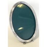 A large oval Sterling silver picture frame on ball