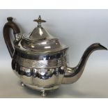 A Georgian silver bright cut teapot on ball feet.