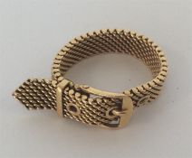 A 9 carat ring in the form of a belt with textured