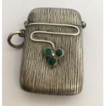 A stylish silver vesta with vine decoration. Appro