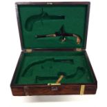 A mahogany box fitted for duelling pistols with br