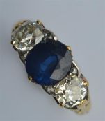 An 18 carat sapphire and diamond three stone ring