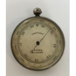 A heavy silver pocket barometer with silvered dial