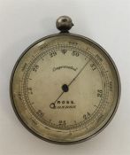 A heavy silver pocket barometer with silvered dial