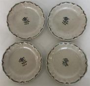 Four Faience shallow dishes painted with a central