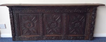 An Antique oak panel carved with flowers and plank