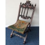 A mahogany carved folding chair decorated with flo