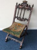 A mahogany carved folding chair decorated with flo