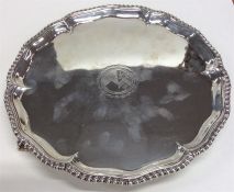 A George III silver crested salver with gadroon ri