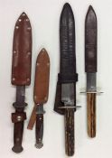 A group of four old knives contained within leathe