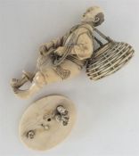 An Antique carved ivory figure of a man carrying a